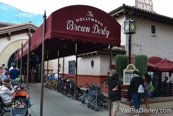 Foto do exterior do Hollywood Brown Derby, no Hollywood Studios. Há um toldo marrom-avermelhado com o nome do restaurante na entrada.  