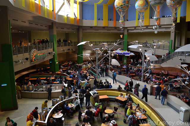 Foto da praça de alimentação do Epcot onde fica o Sunshine Seasons, bem ampla e com balões coloridos na decoração 