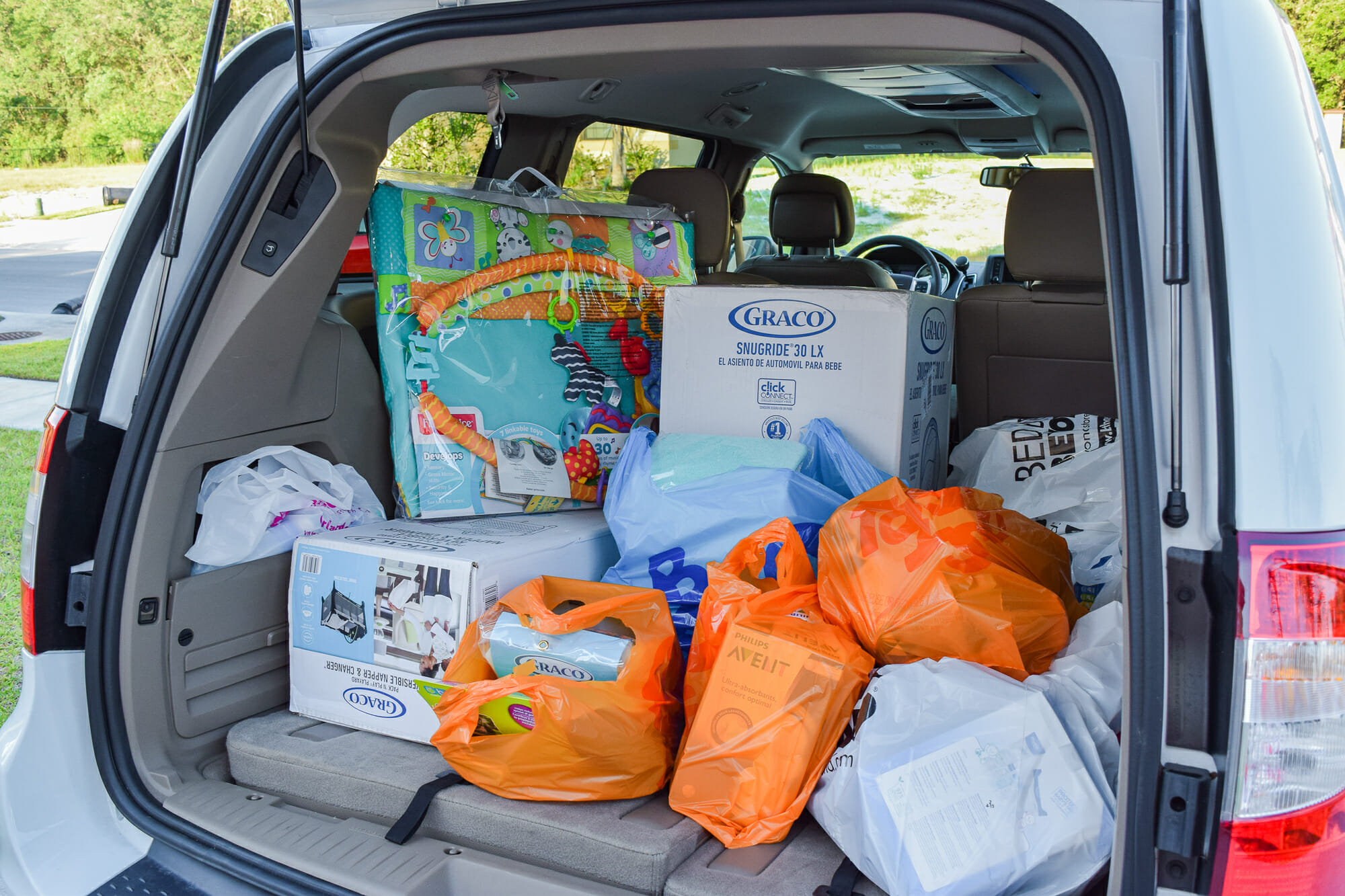 Foto de um porta-malas de carro cheio de sacolas de compras