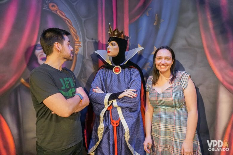 Como reservar restaurante na Disney - Rainha Má da Branca de Neve no jantar do Storybook Dining. Foto do Storybook Dining, mostrando a Renata e o Felipe posando para a foto com a Rainha Má da Branca de Neve 