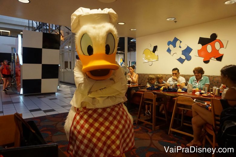 Foto do Donald vestido de chef, com  chapéu e um avental xadrez vermelho e branco. 