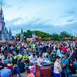 Foto do Magic Kingdom em um dia muito cheio, com visitantes ao redor do castelo da Cinderela e o céu escurecendo ao fundo.