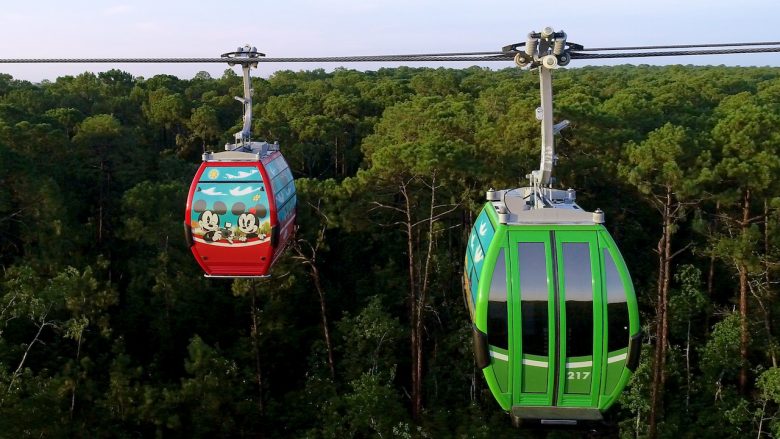 Disney Skyliner Foto das gôndolas do Disney Skyliner, uma verde e outra vermelha com desenho da Minnie e do Mickey
