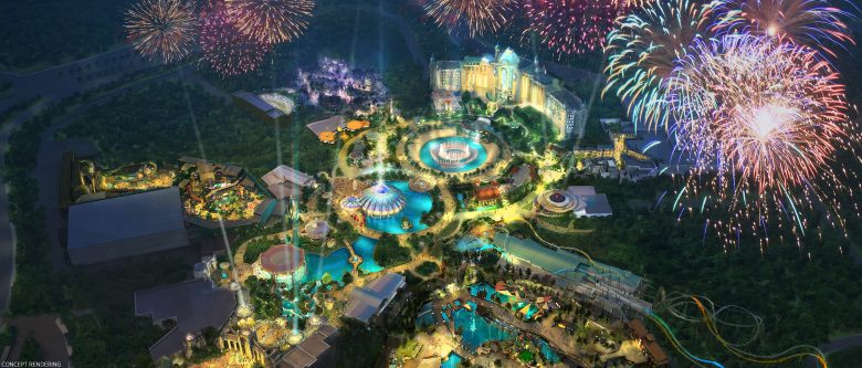 Concept art de como será o Epic Universe, o novo parque da Universal. A imagem é uma vista de cima de um parque de diversões iluminado à noite, com fogos de artifício no céu. 