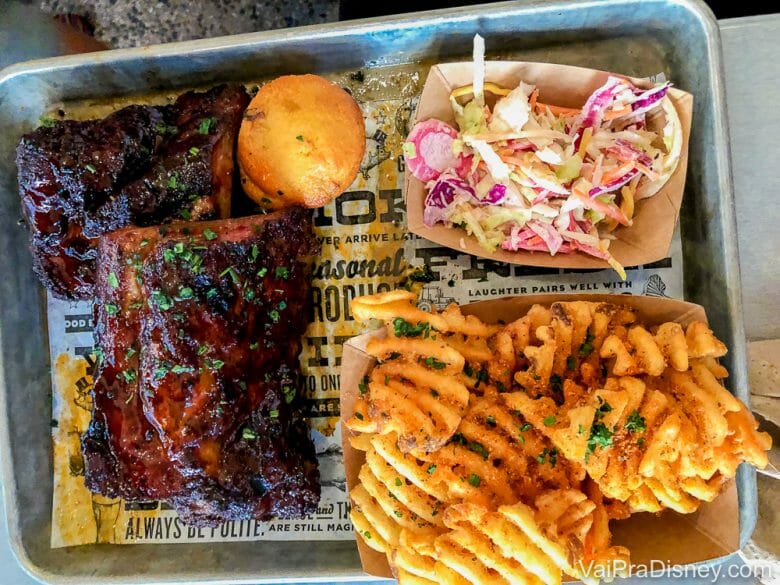 Foto da comida do Polite Pig, um dos restaurantes que vai reabrir em Disney Springs - costela de porco, salada e batatas fritas. 