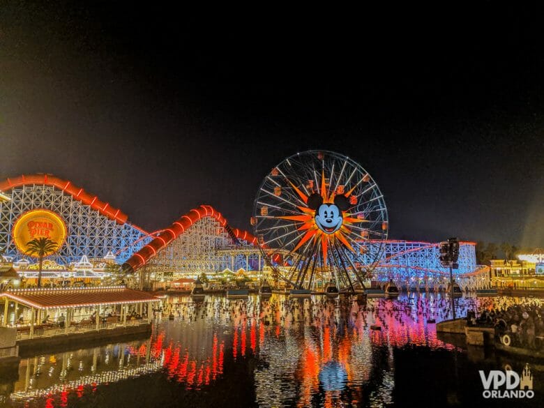 Imagem da roda-gigante do Mickey que fica no Disney's California Adventure à noite, com o parque todo iluminado. O parque agora tem data para reabrir.