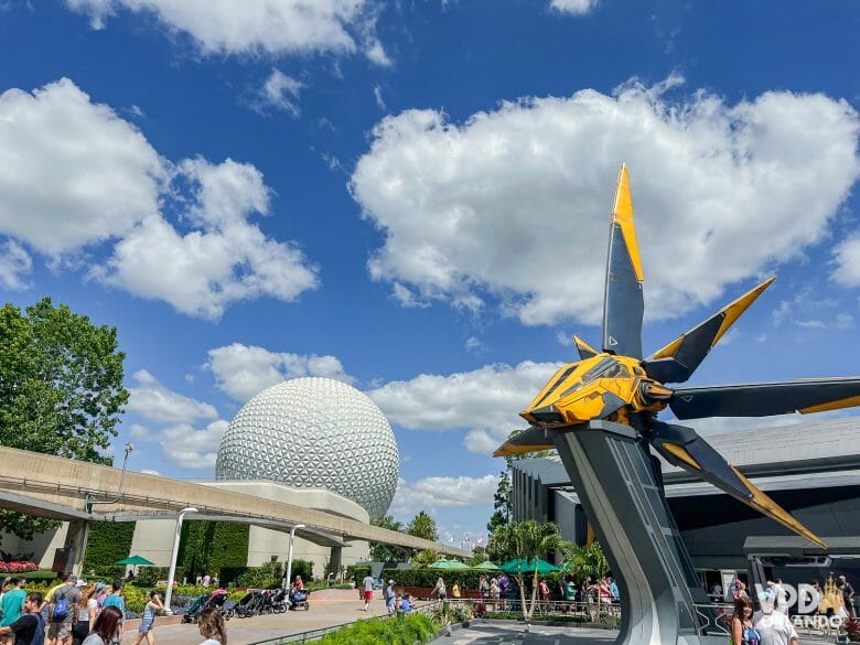 Foto da fachada da Guardians of the Galaxy: Cosmic Rewind. Há uma nave preta e amarela em frente, e do lado esquerdo ao fundo dá pra ver a bola do Epcot e o trilho do Monorail.